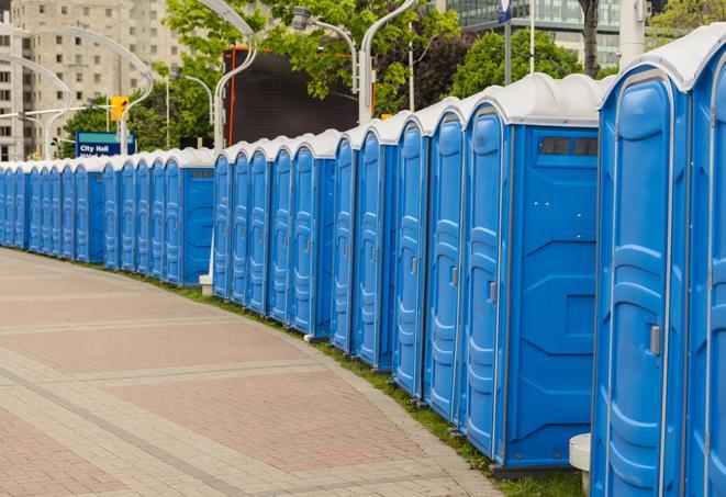 a row of portable restrooms at an outdoor special event, ready for use in Cottleville